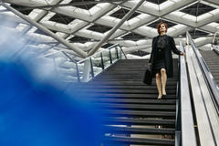 A woman walking down the stairs.