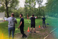 4 men doing archery.