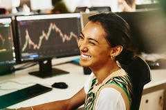smiling woman in front of digital data dashboard