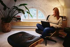 Woman in a sofa working on her laptop