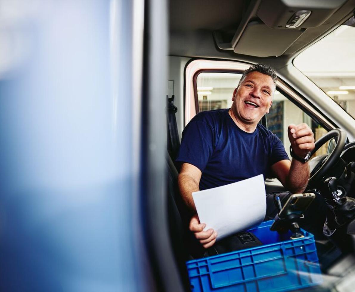 Photo of a truck driver sitting in his truck